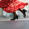 Female Flamenco dancer, showing red skirt, ankles and black heeled shoes