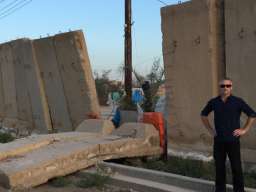 Damian and a blast wall in Baghdad