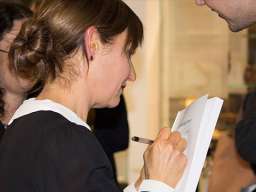 A/Prof Dennis signing a book