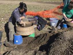 Masters of Archaeology students sift every bucket of earth