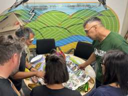 : Looking at map of the Peninsular de Yucatán Alliance for Community-Based Tourism. Left to right: Manuel Xool Koh, Susannah Smith, Kylie Message-Jones, Bianet Castellanos, Paul Girrawah House. Photograph by Carolina Maranon-Cobos.