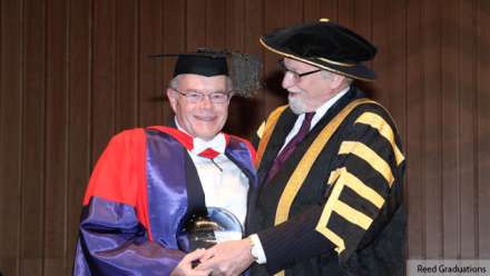  Distinguished Professor Bob Goodin (left) receives the Peter Baume award from ANU Chancellor Professor Gareth Evans. Image courtesy Reed Graduations. 