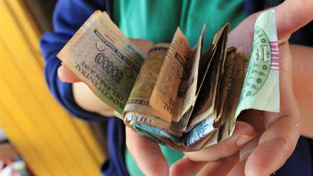  A microcredit group makes its collective loan payment. Image by C. Schuster 2010
 