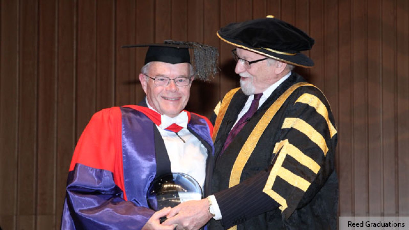  Distinguished Professor Bob Goodin (left) receives the Peter Baume award from ANU Chancellor Professor Gareth Evans. Image courtesy Reed Graduations. 