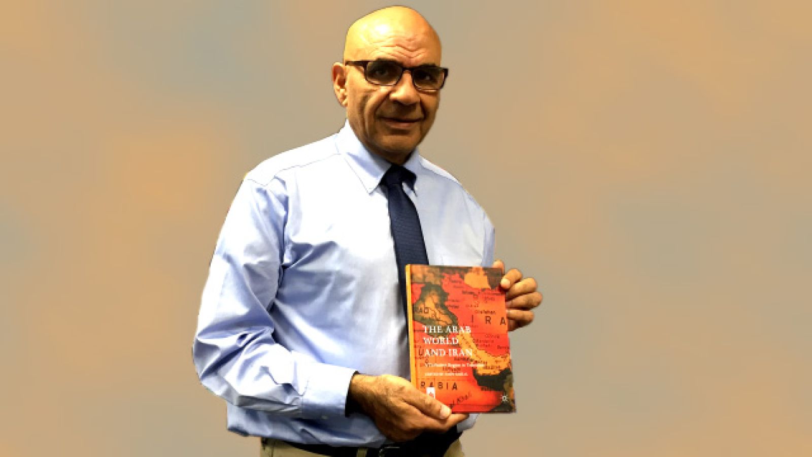 Professor Amin Saikal with his latest book, based on conference which marked the 20th anniversary of the ANU Centre for Arab and Islamic Studies.