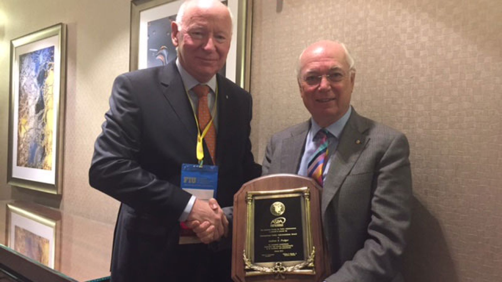  Professor Podger AO (right) with his award "for his work on a global scale to strengthen the public sector and understanding of public service". 