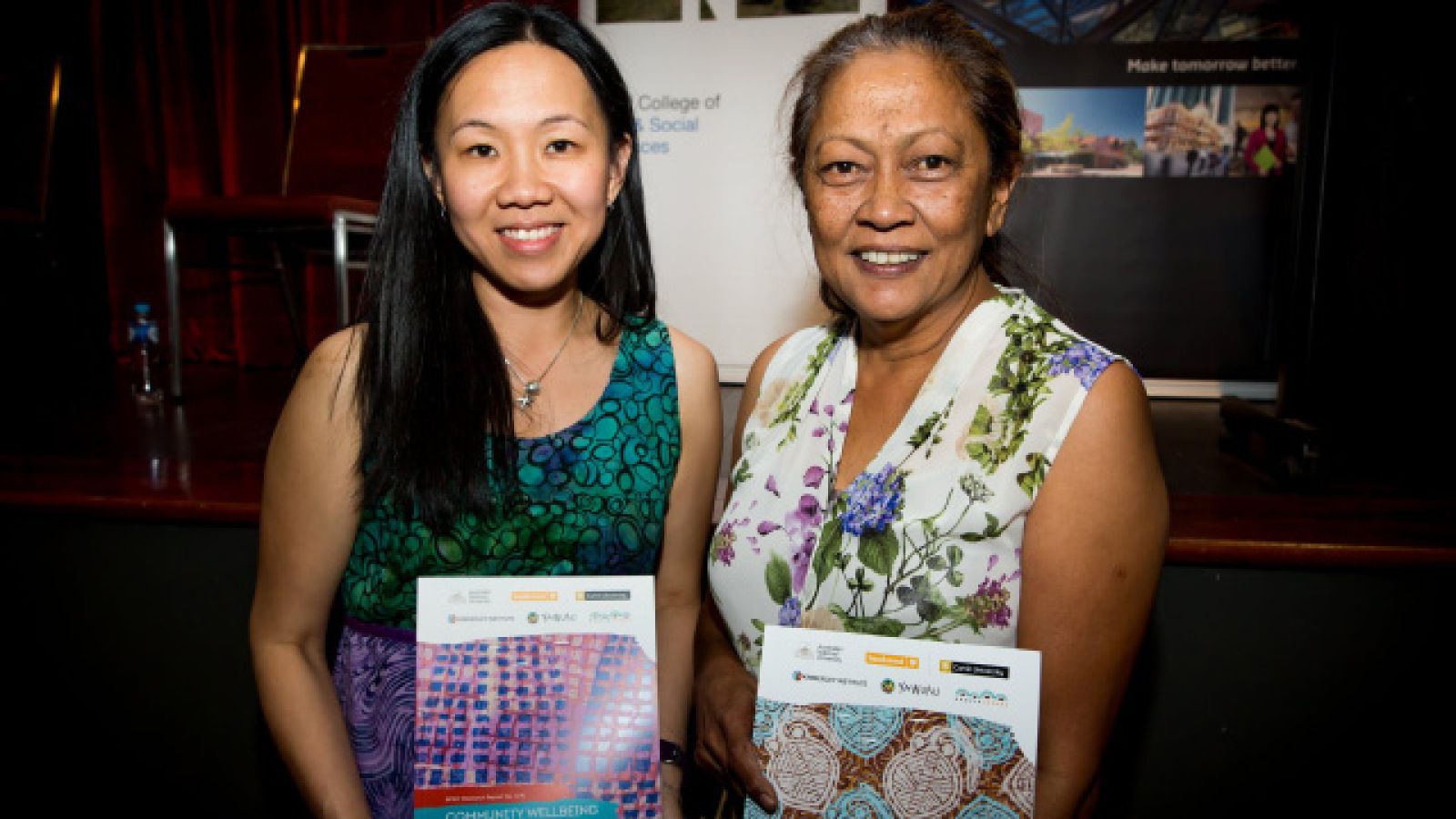 Mandy Yap (left) and Eunice Yu with their report, which features cover designs by Yawuru artists. Image by Julia Rau Photography.