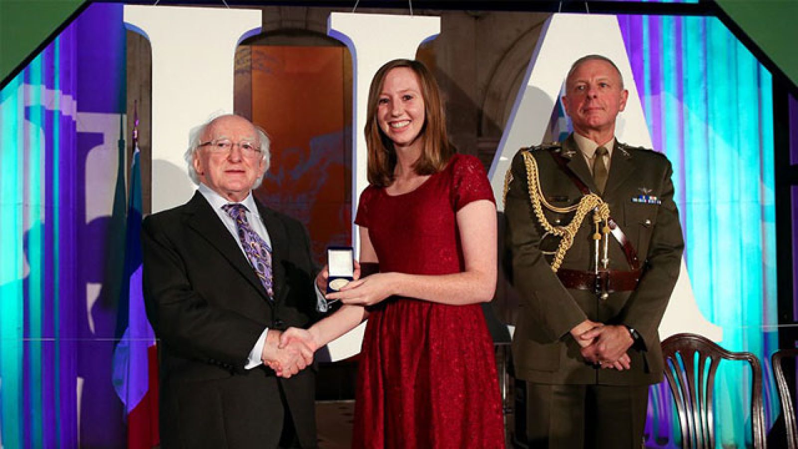 Arts/Law student, Matilda Gillis, is presented with her gold medal from the President of Ireland Mr Michael D. Higgins. Image supplied.