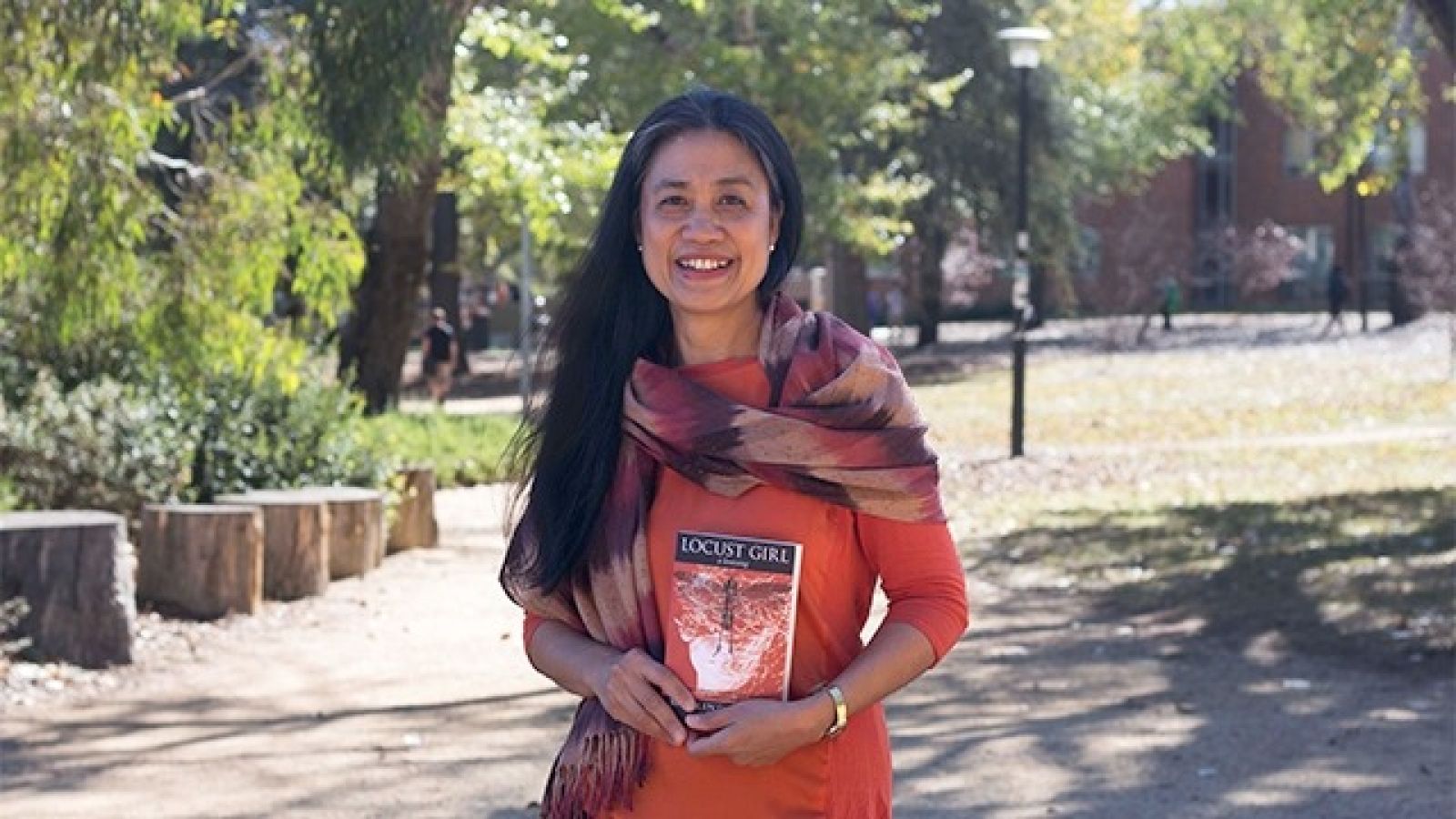 Dr Merlinda Bobis with her book Locust Girl. A Lovesong.