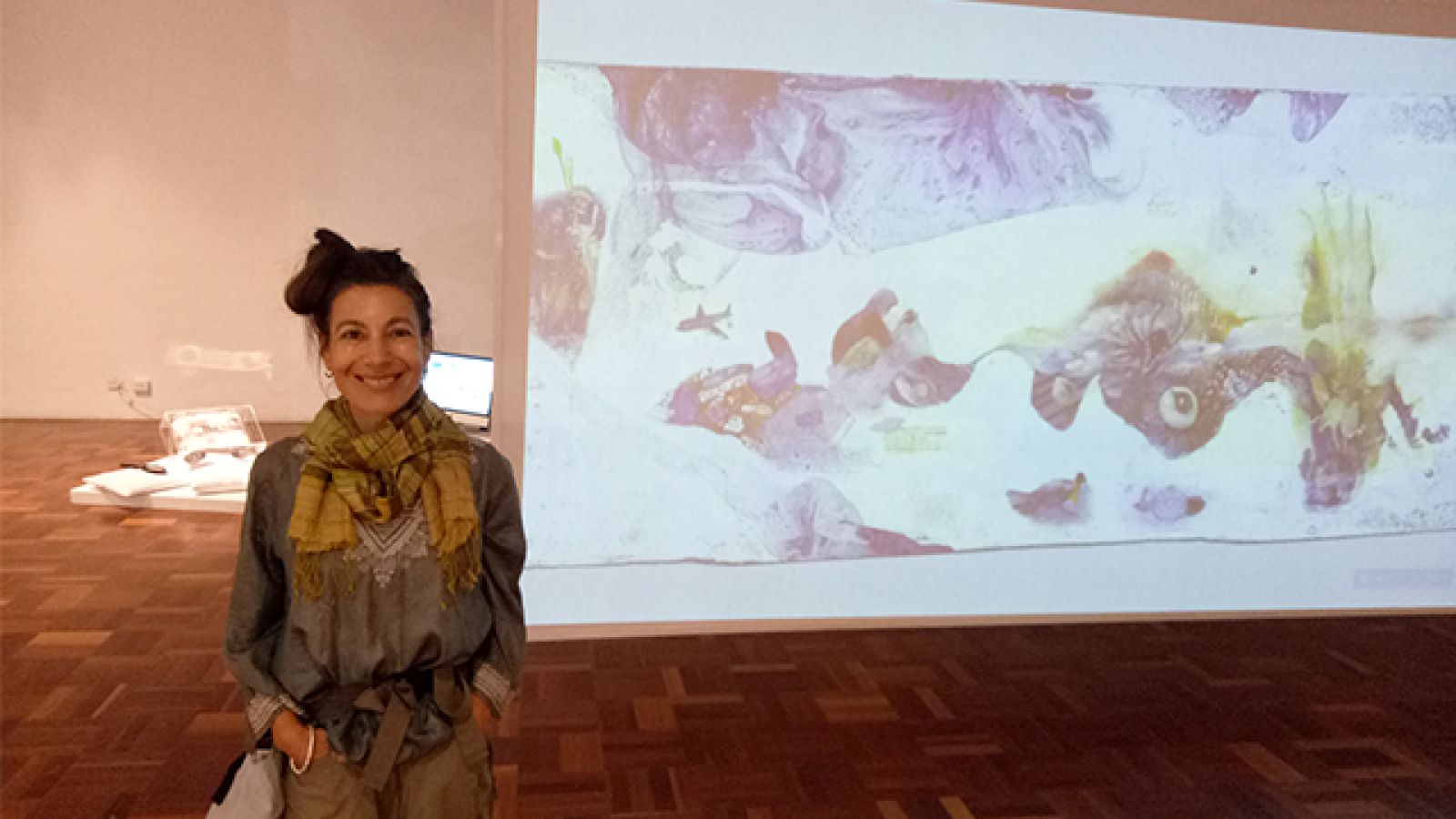 Michal Glikson with a projection of part of her work.