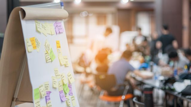 Business people meeting at office and use post it notes to share idea. Brainstorming concept